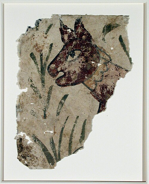 A fragment with an animal head (cat? jackal?) with simple stalks of vegetation, , 