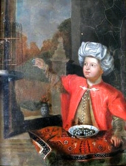 A boy in a turban feeding a bird., , 